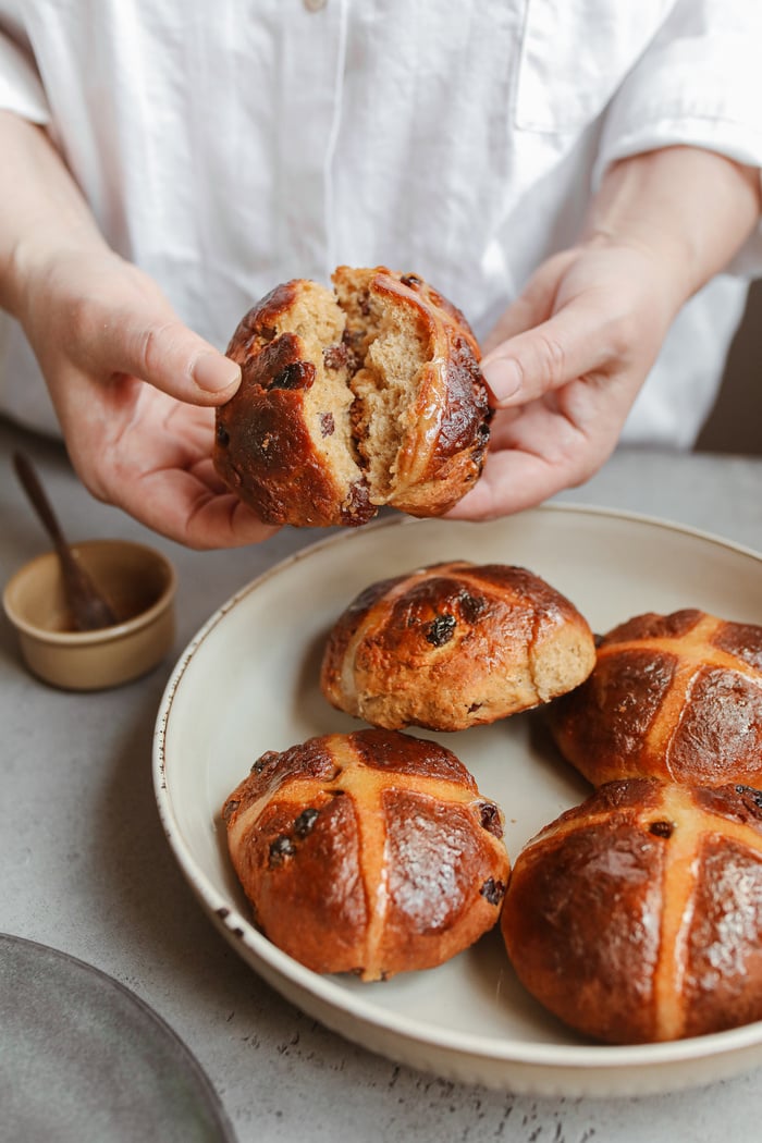 Baker Breaking Fresh Bread 